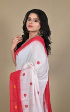 Side profile showing red border and woven star butis on white cotton