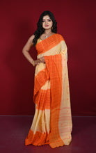 Model in cream Begampuri handloom saree with orange checked border