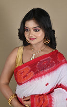 Detail of red ikat temple border against off-white handloom cotton