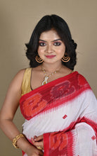 Neckline drape showing red and orange ikat border of the saree