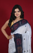 Model in white Begampuri handloom cotton saree with black ikat temple border