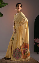 Model wearing butter yellow Jamdani saree with matching blouse showcasing handloom floral medallion details.
