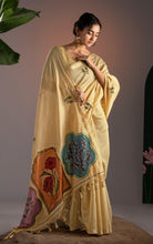 Model posing in pastel yellow Jamdani saree displaying the multi-colored arch motifs and handcrafted tassels.