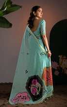 Back view showing full pallu spread of a sea green Jamdani saree with pink, black, and orange floral medallions.