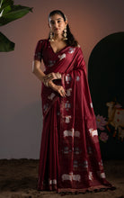 Front view of deep wine maroon soft cotton Jamdani saree featuring traditional white cow and lotus motifs.