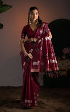 Draped front view highlighting the decorative pallu with woven cow motifs and tassel finish.