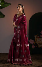 Side profile displaying the elegant woven border and graceful pallu drape.